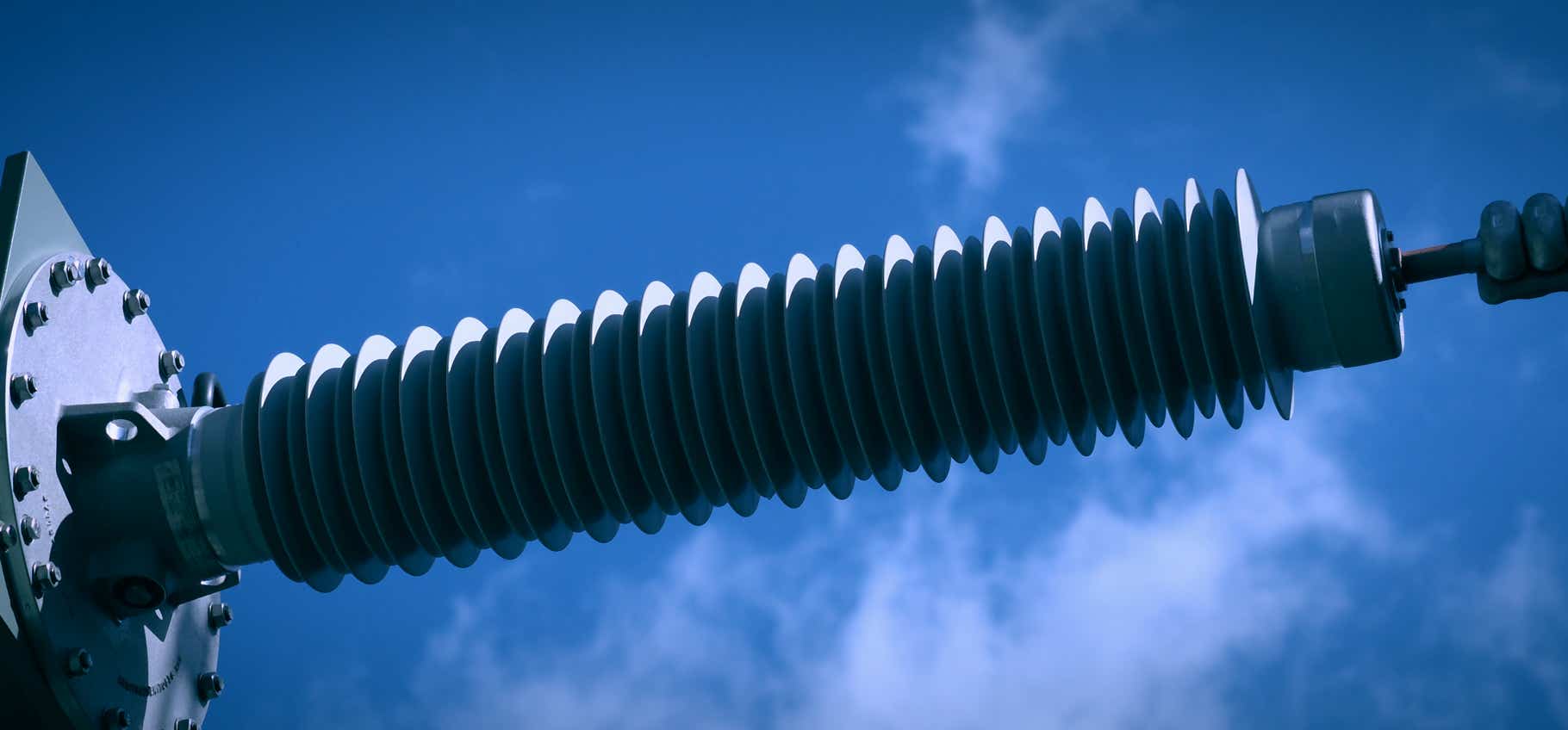 Foto Hochspannungsisolator, Zuleitung Oel-Transformator Umspannwerk von Amprion, blauer Himmel